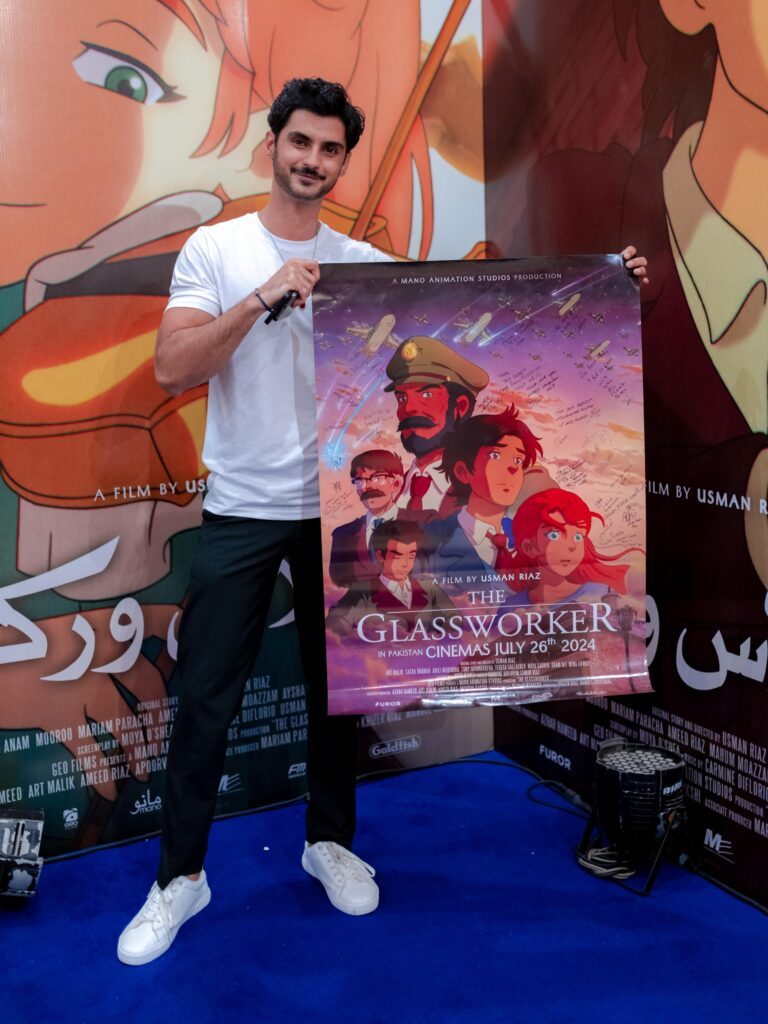 Sarim Kidwai holds up a poster for 'The Glassworker'