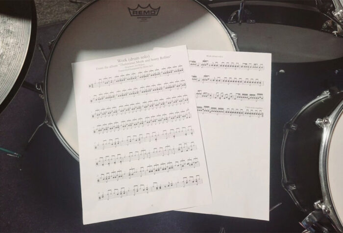 Music sheets rest on a drum head