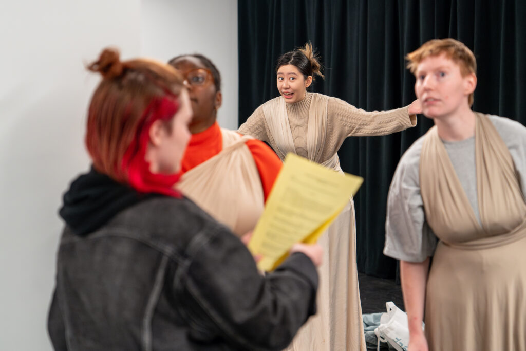 Four members of the cast and crew rehearse the play