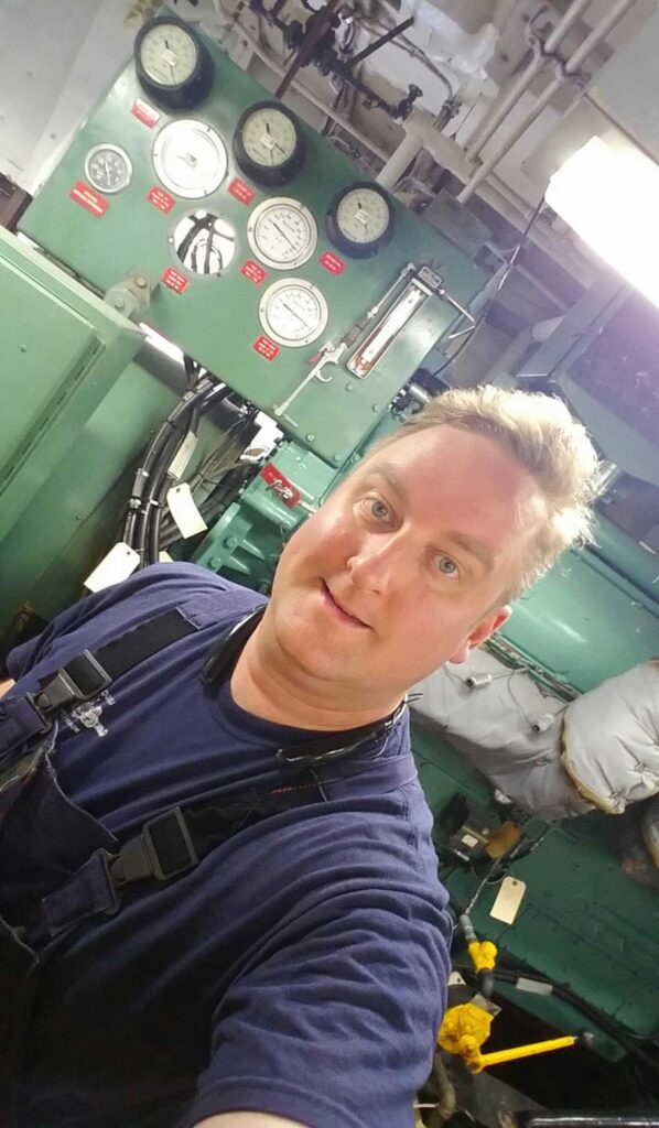 Justin Ramey in the engine room of a ship