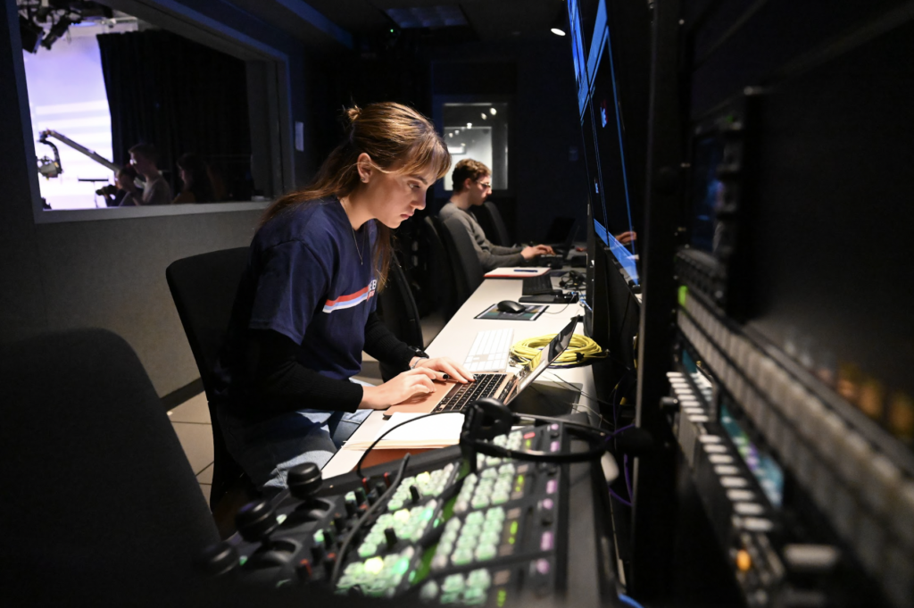 Emma Siebold works from a production room desk