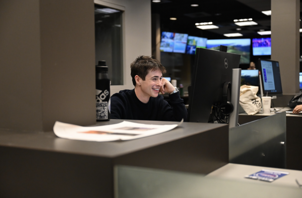 Daniel Cordova Rubio smiles from a desk