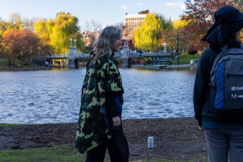 Kate Farrington walks along the Boston Public Garden pond while giving a tour