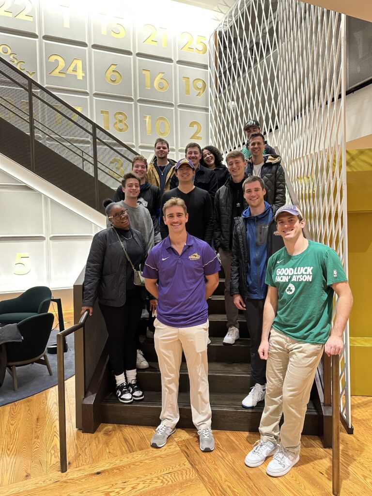 A group of students standing on stairs on the inside of the Boston Celtics arena