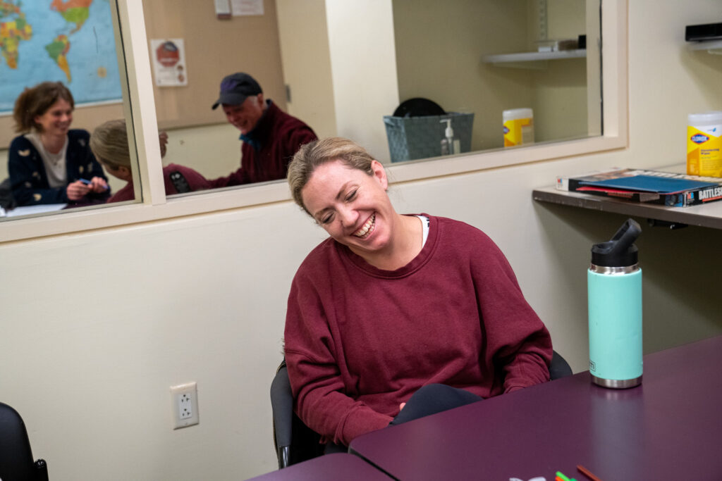 Jayme Kelly smiles during group therapy