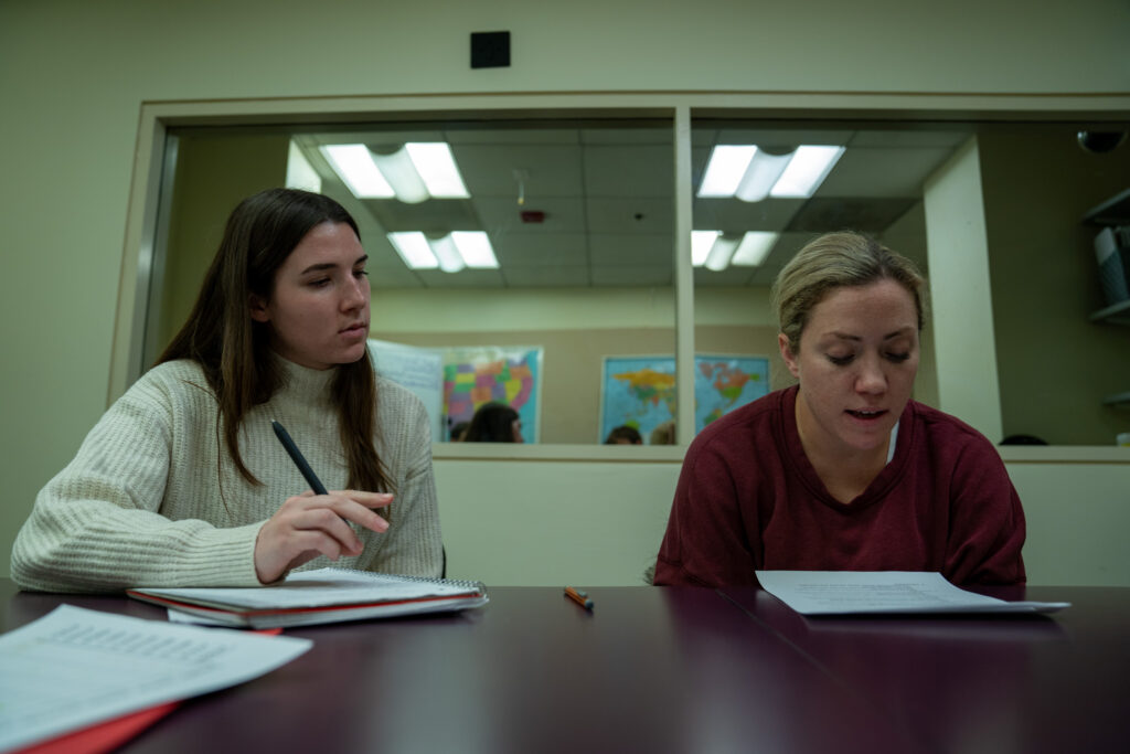 Grace Flanagan works with Jayme Kelly to read 