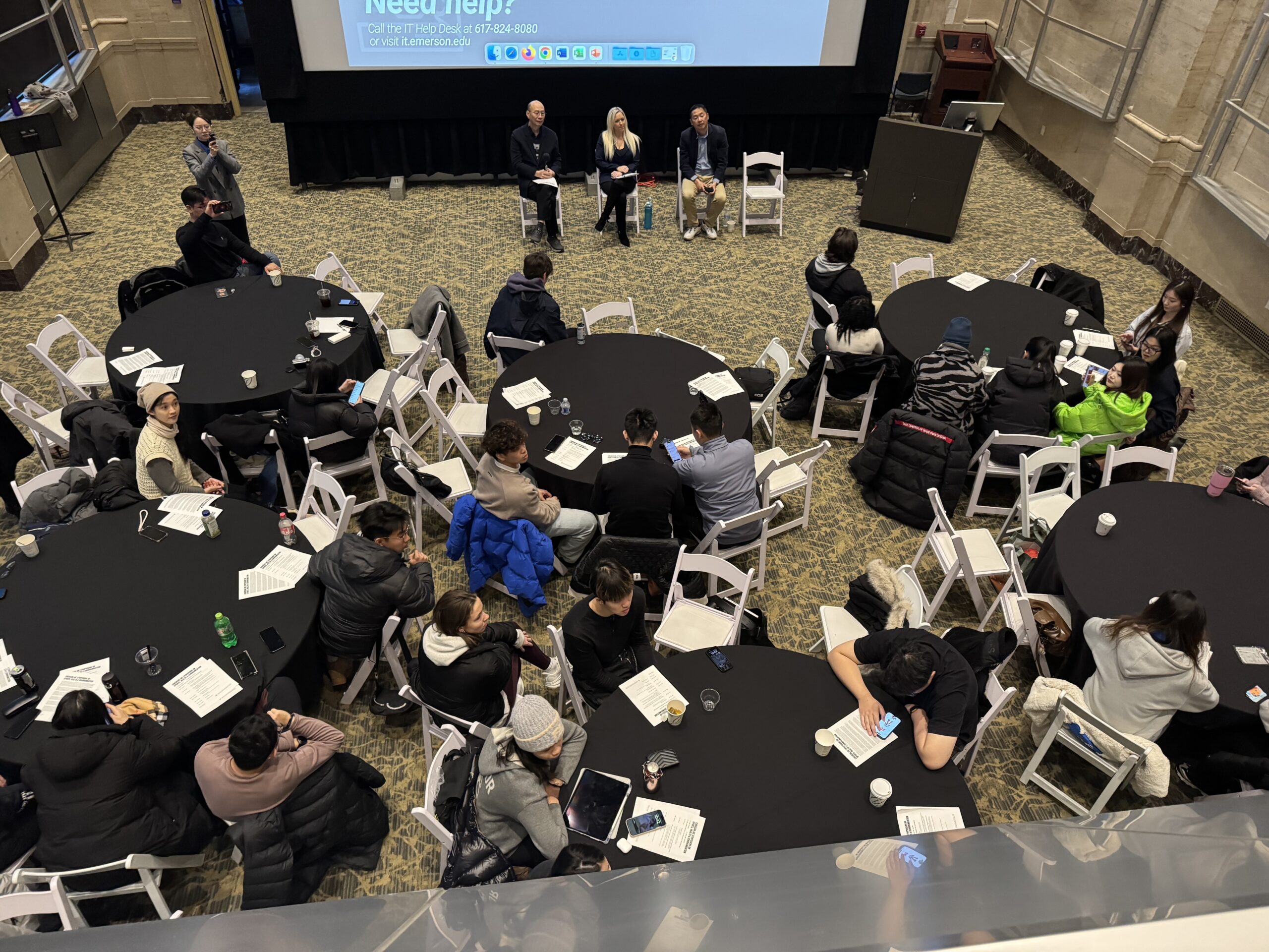 Sitting at roundtables with each other, Students brainstorm on how language and AI influence perceptions of success and health in sports during interactive roundtable sessions. [Photo/Molly Loughman]