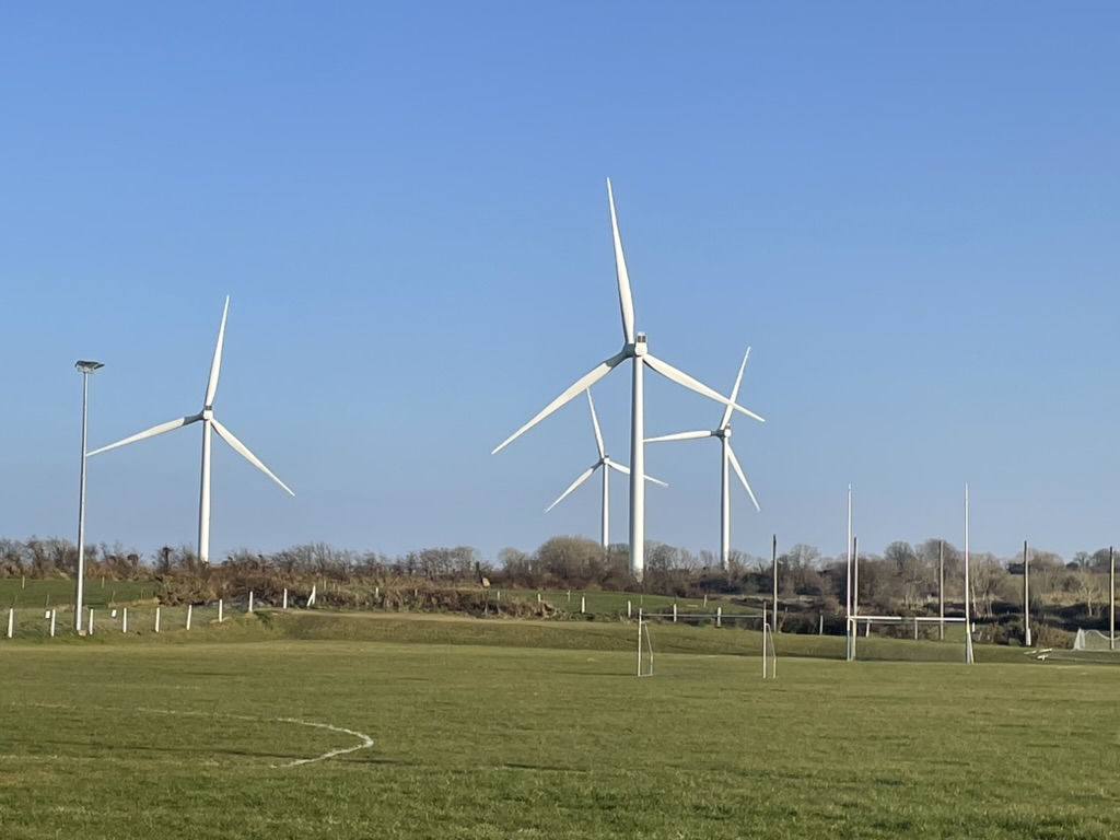 A wind turbine farm in Killala, Ireland  towering over the local community youth sports pitches.