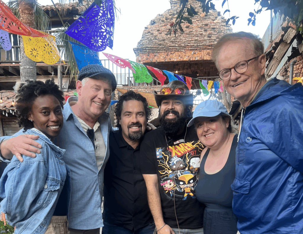 Five people pose for a photo