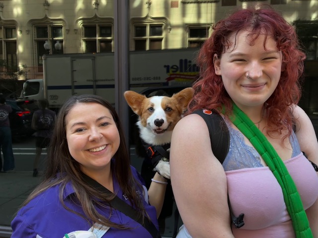 Desiree Baker, Creampuff the dog, and Kat Fristrom pose for a photo on the street