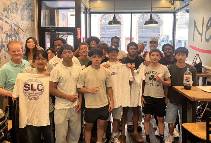 Group of teenagers and faculty inside local restaurant