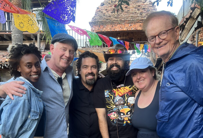 Five people pose for a photo