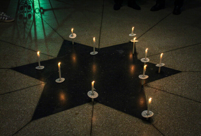 Lit candles atop a star emblem part of that floor