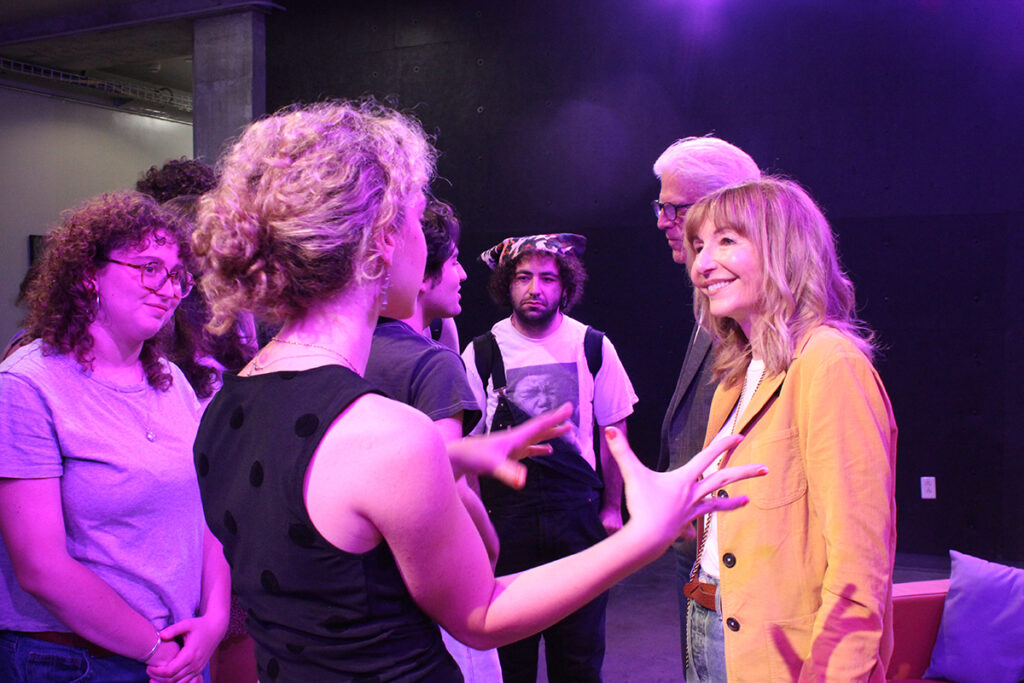 Student in black tank top talks to actor Mary Steenburgen