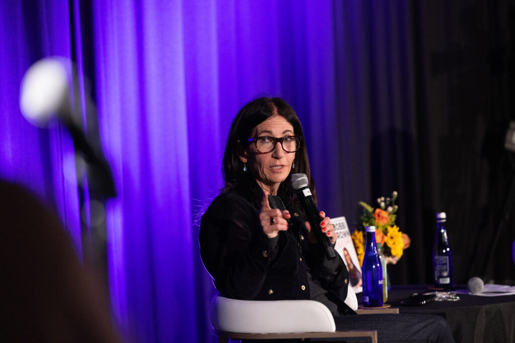 Bobbi Brown answers a question while holding a mic