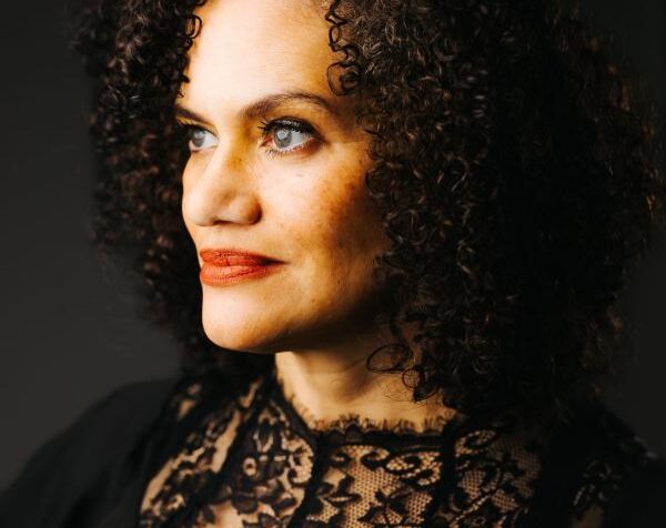 A side profile photo of a person with curly hair.