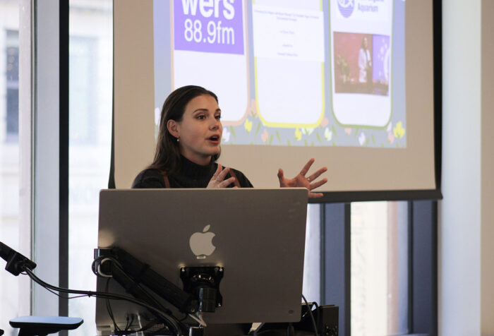 Suzie Hicks has her hands up while speaking to a class