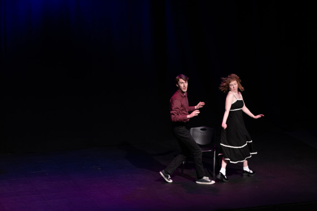 Two people dance on stage