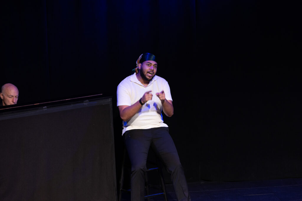 A person sits a stool while auditioning