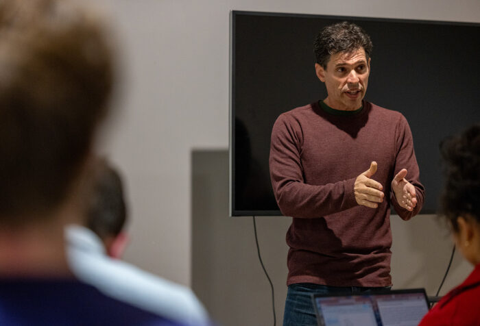 Max Brooks stands while talking to an audience