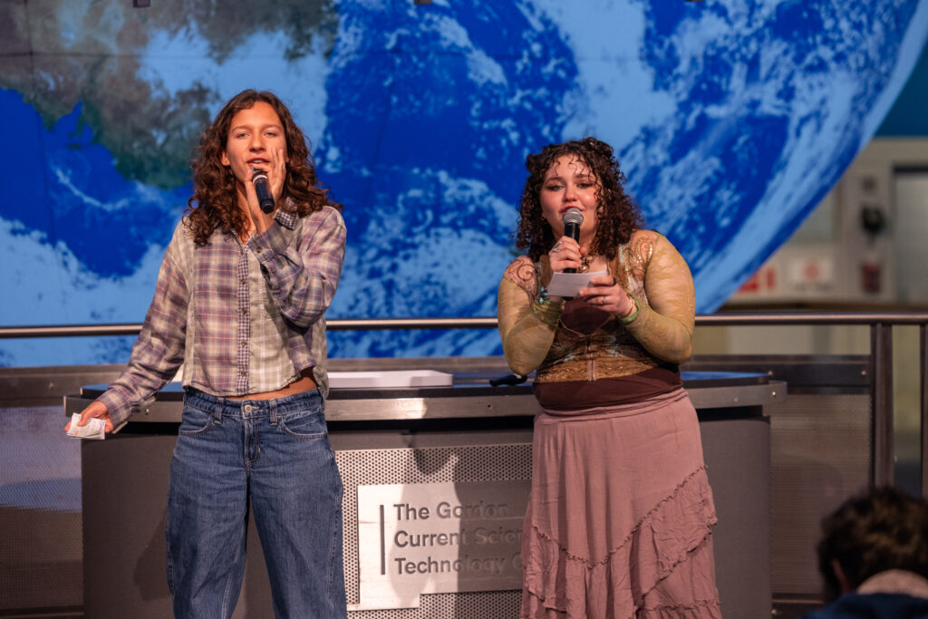 Two people speak using microphone