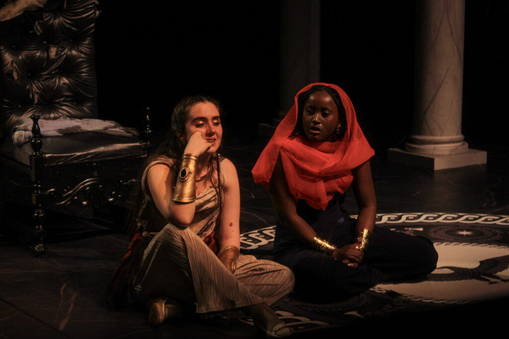 Two people sit on stage during the show