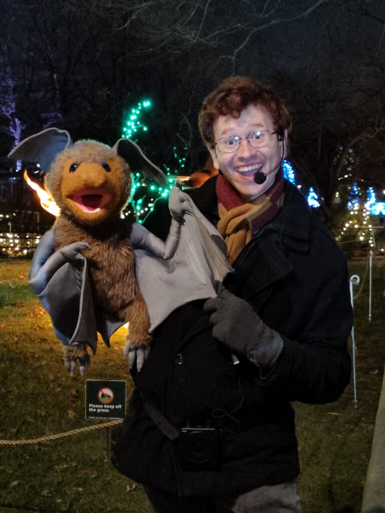 Ricky Downes III holds a bat puppet as a tour guide at the Bronx Zoo