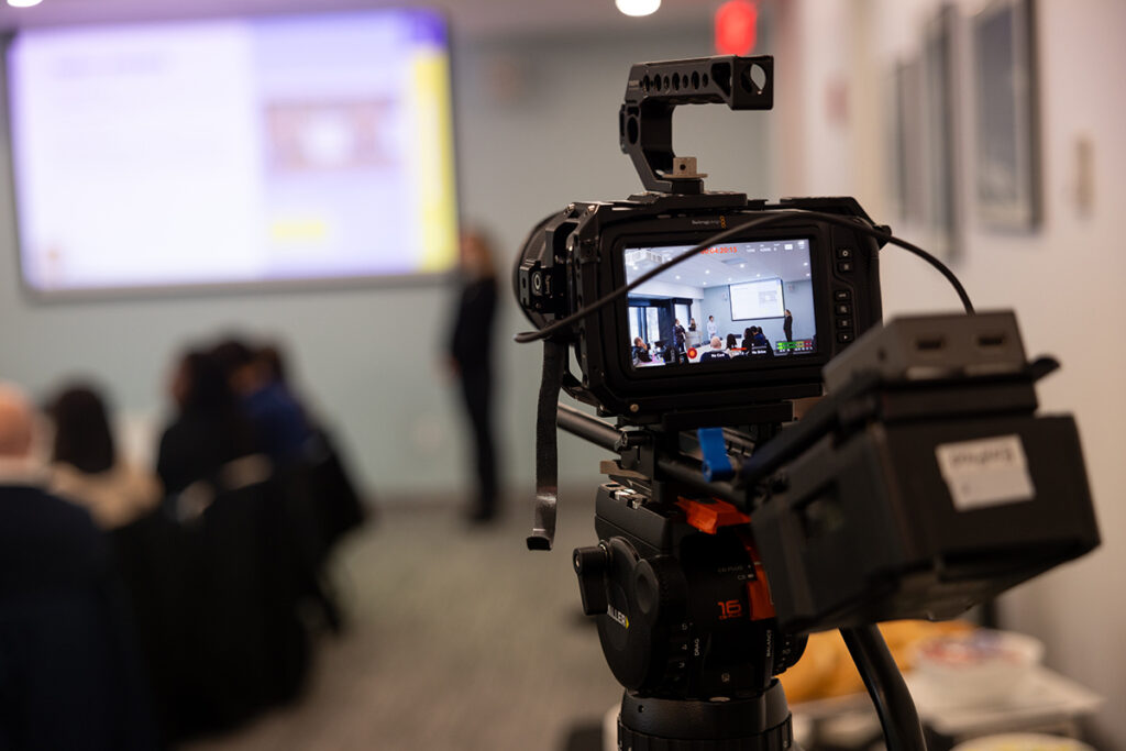 Photo of the viewfinder of a camera, pointed at a classroom presentation.