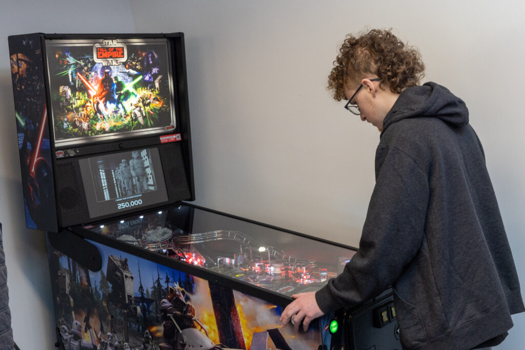 A person plays pinball