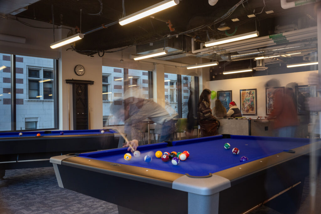 A blurry image plays pool