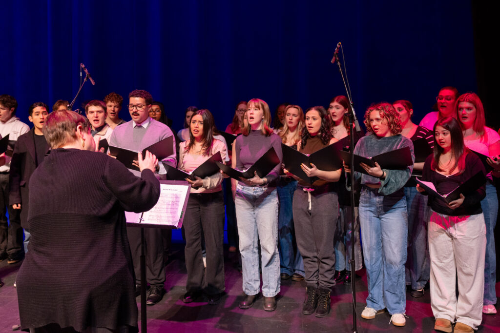 Photo of musical theatre students and associate professor Sariva Goetz rehearsing before their performance with actress Sutton Foster
