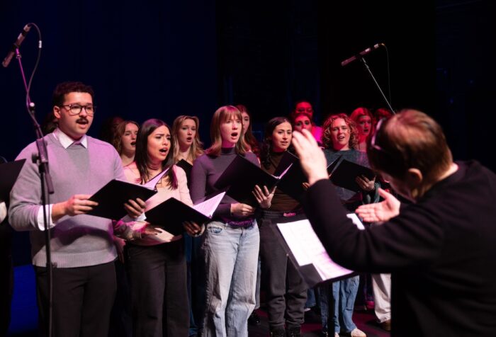 Photo of musical theatre students and associate professor Sariva Goetz rehearsing before their performance with actress Sutton Foster