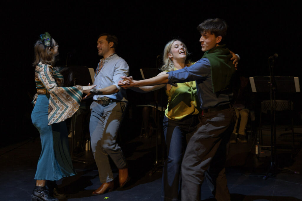 Four people dance as part of the musical