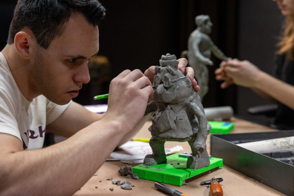 Michael Greene sculpts his clay character Wadsworth