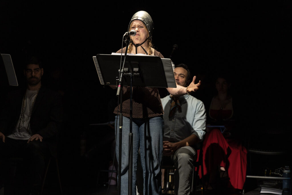 Ella Rae Barret sings with an easel in front of her