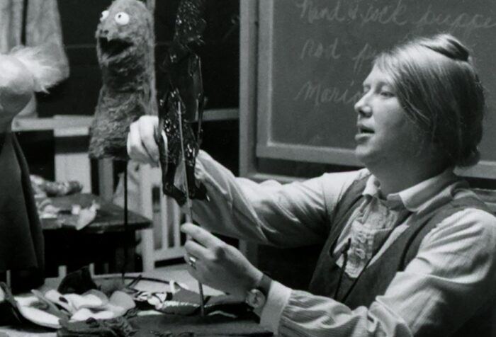 Black and white photo of Mary Ellen Adams in the costume shop at Emerson