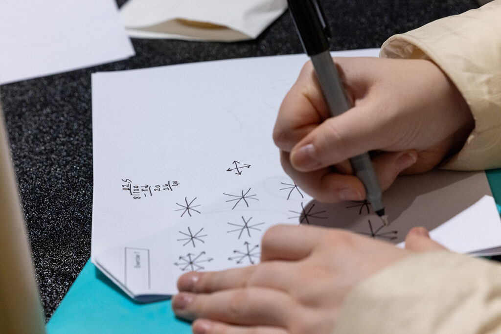 hand draws circles of arrows on paper