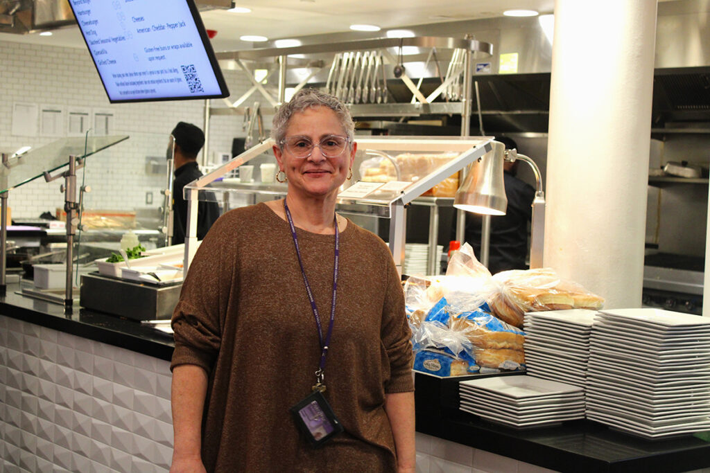 Glenda Torres stands in Dining Center