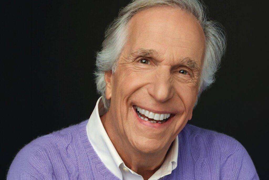 Henry Winkler in purple sweater
