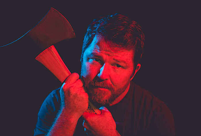 head shot of owen egerton holding an axe