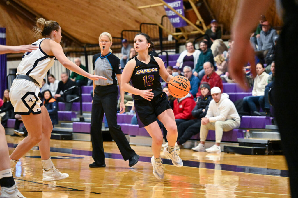 Bri Frongillo dribbles the basketball in front of a defender