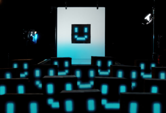 Digital smiley faces watching screen showing digital smiley face