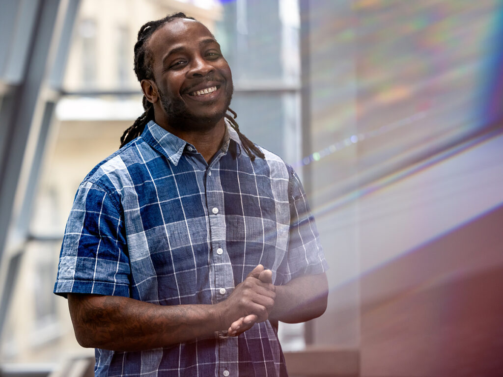 Kenneth Faulk in plaid shirt in front of window