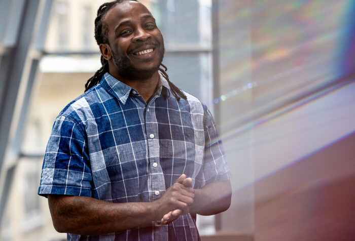 Kenneth Faulk in plaid shirt in front of window