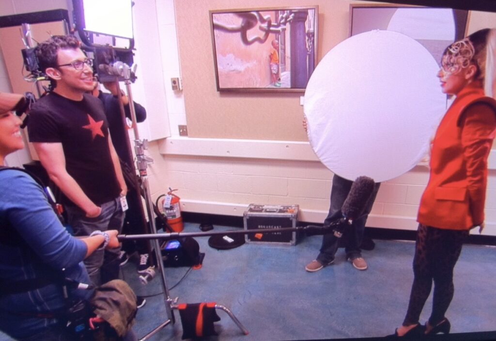 Lenid Rolov on set interviewing Lady Gaga.