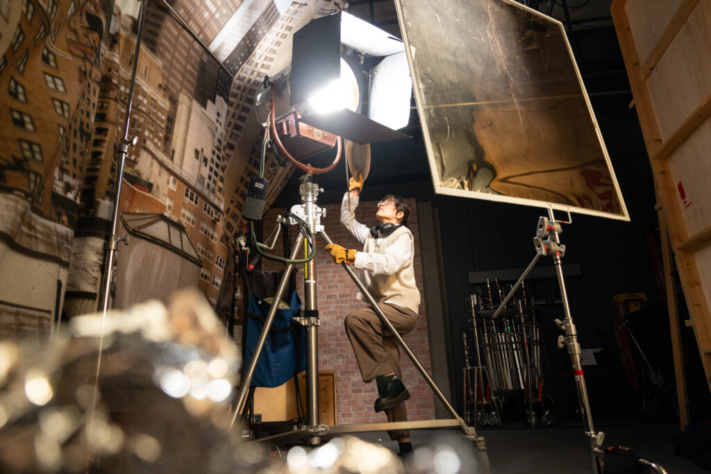 A student works with lighting equipment