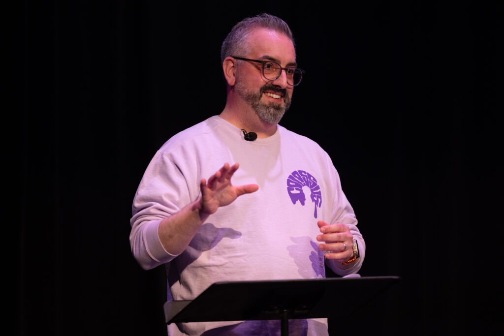 Greg Almeida speaks while standing