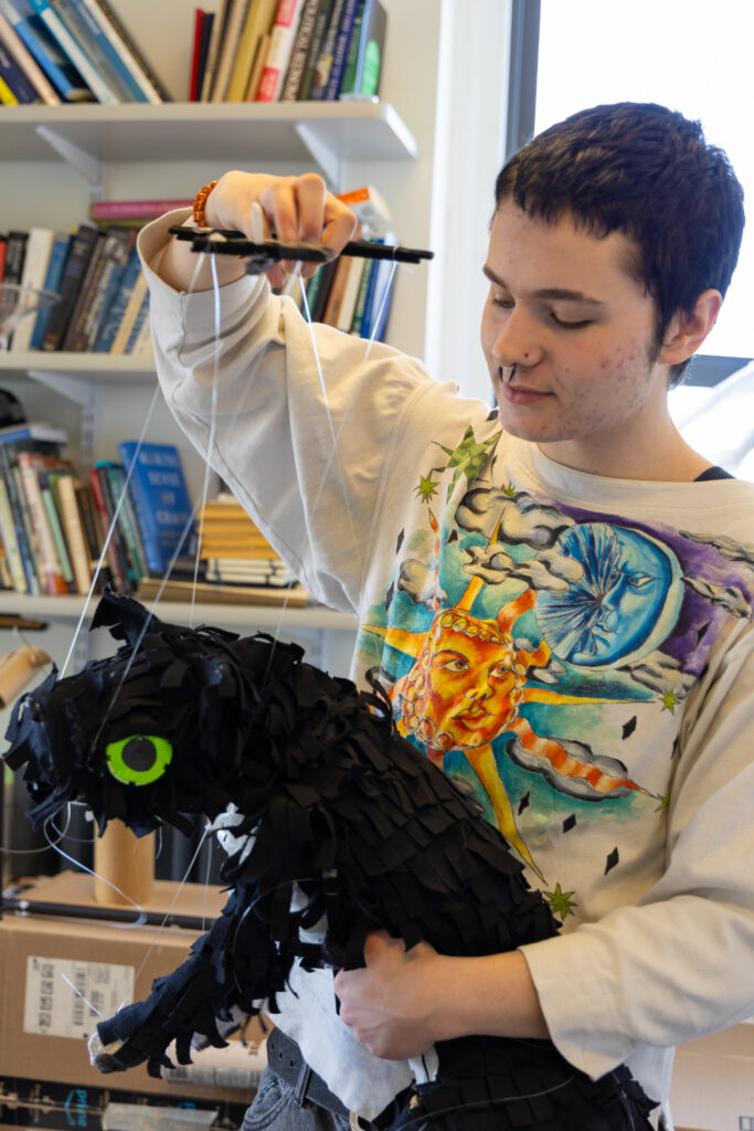 Nel Blinman dangles a puppet she made