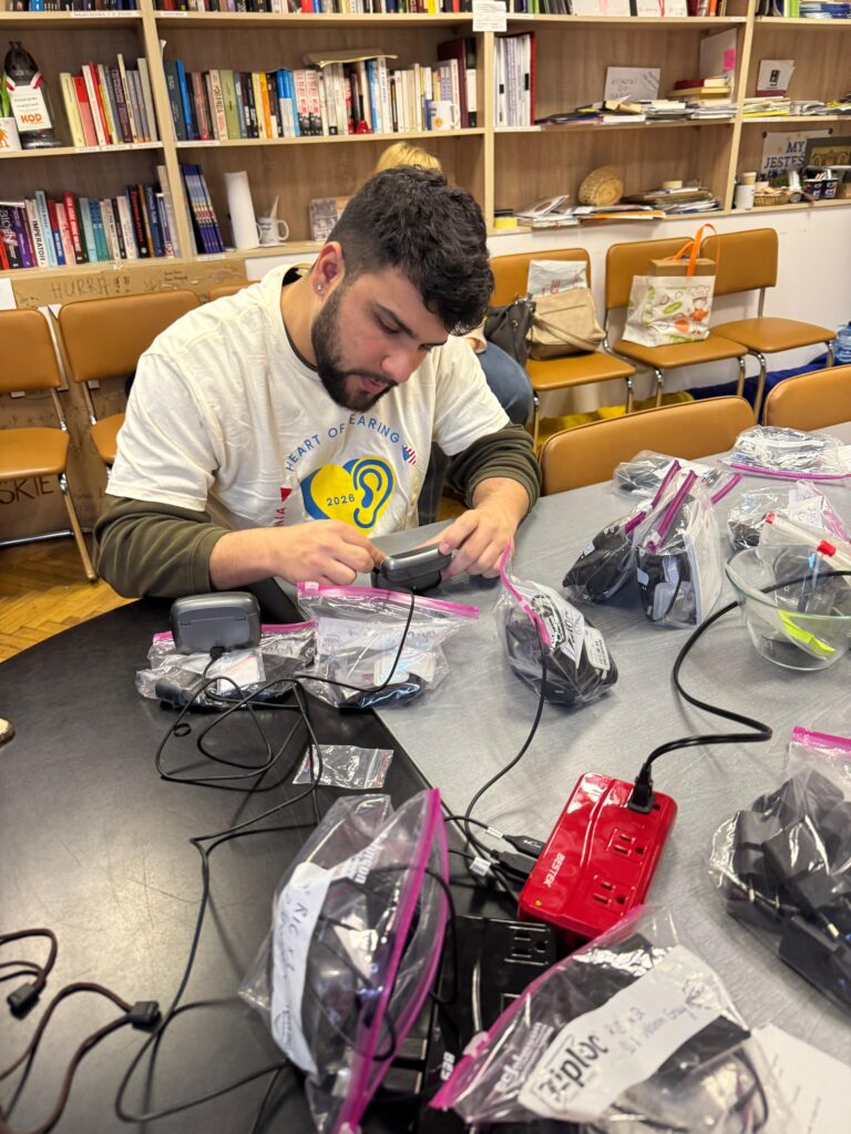 Matt Mascobetto works with hearing devices