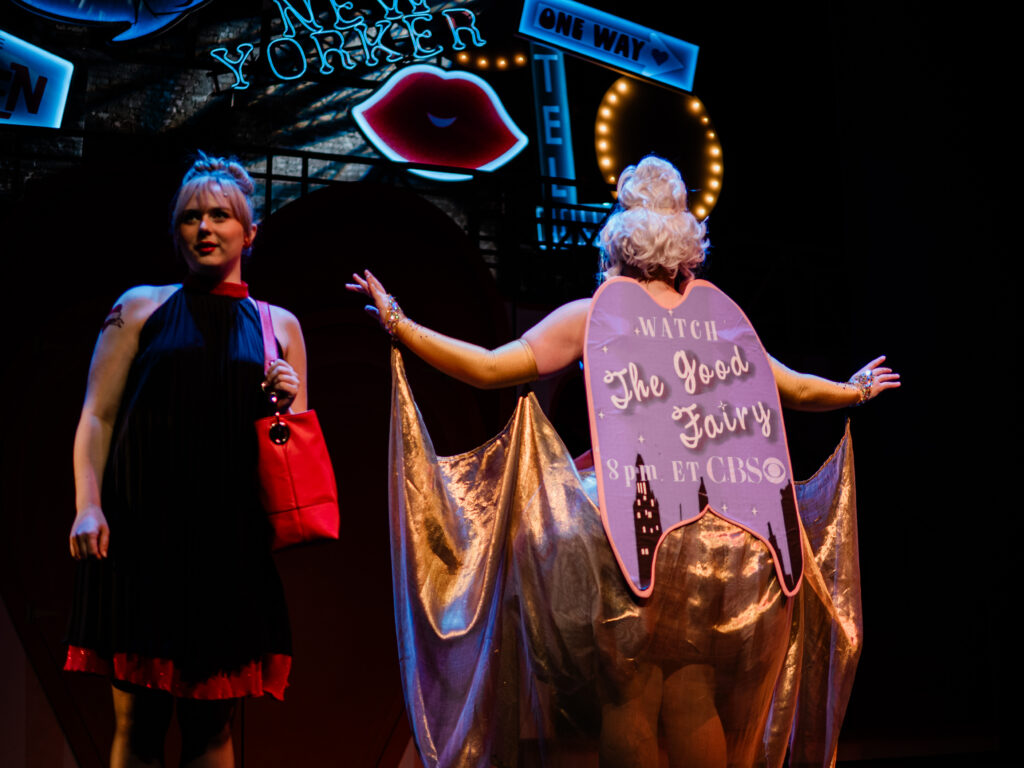 The back of the Good Fairy's dress has a sign that says: Watch The Good Fairy 8 pm ET CBS